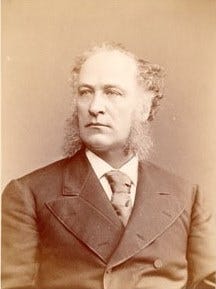 Daniel Dougherty in sepia toned formal one-quarter portrait wearing dark jacket, long tie, white shirt