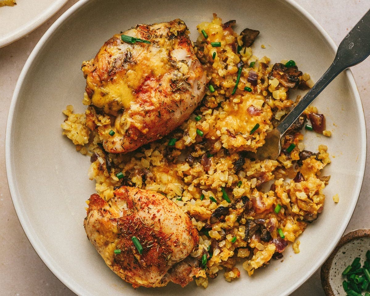 Cauliflower rice and chicken on a plate.