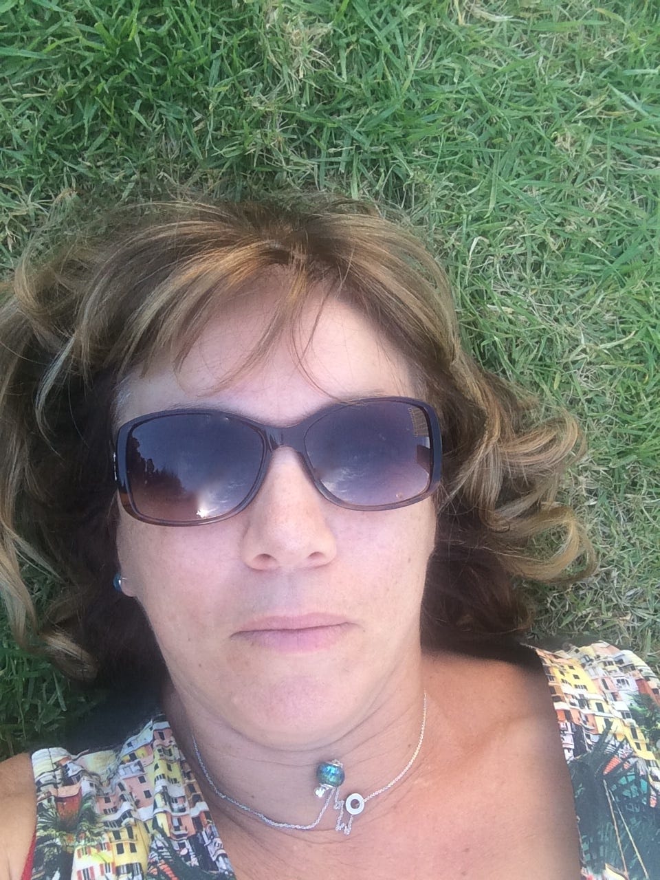 The author wearing sunglasses, lying not the grass waiting for ideas