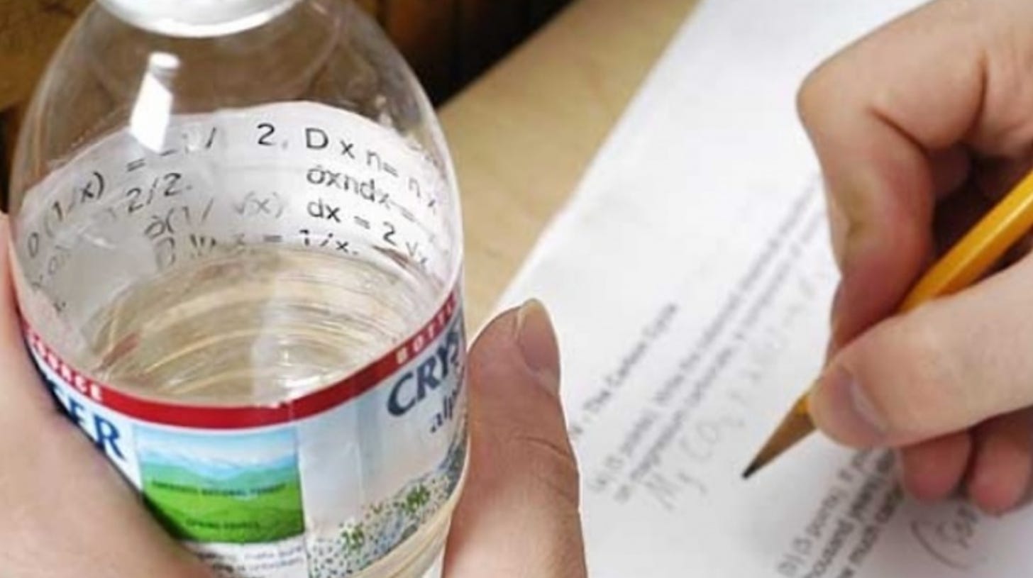 Photograph of a student taking an exam with cheat sheet pasted in bottle