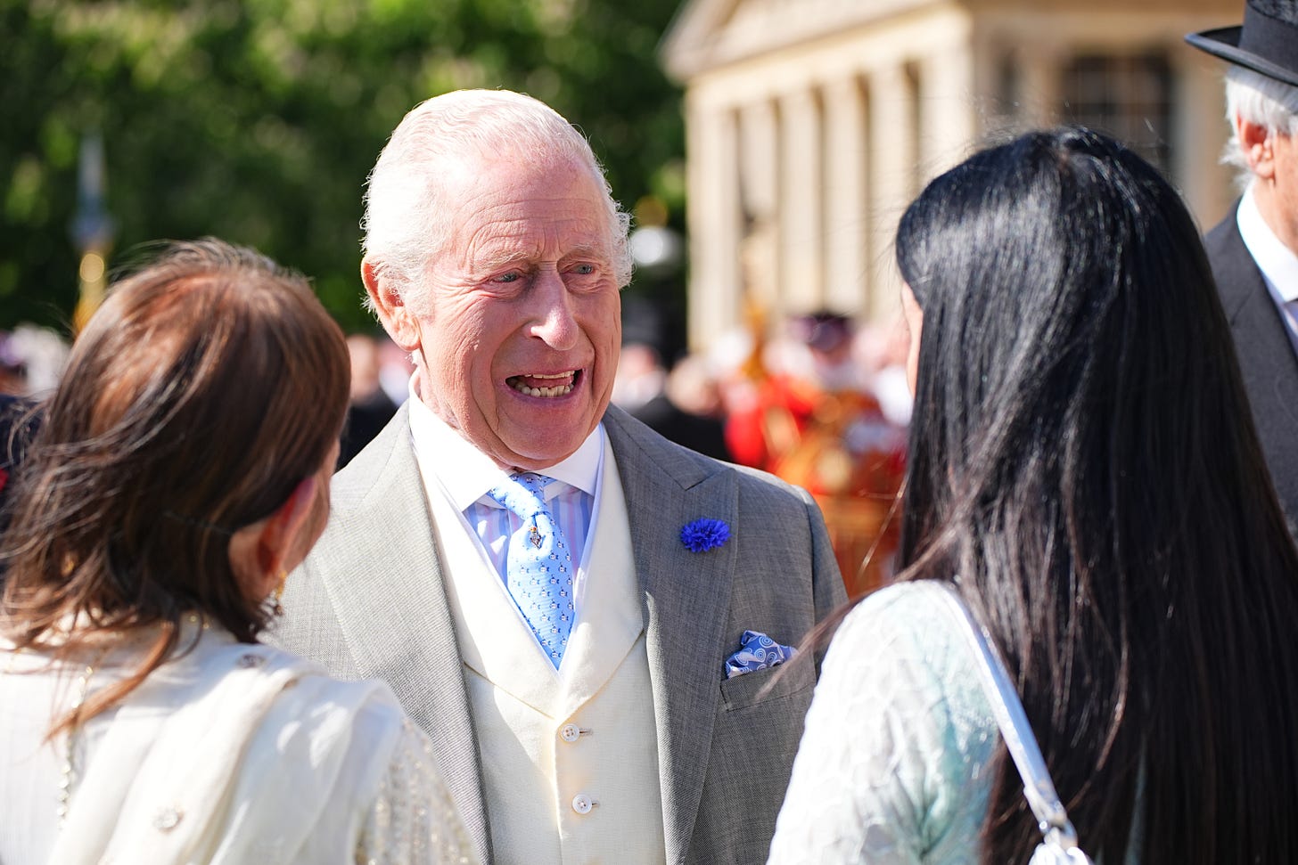 King Charles smiling at guests
