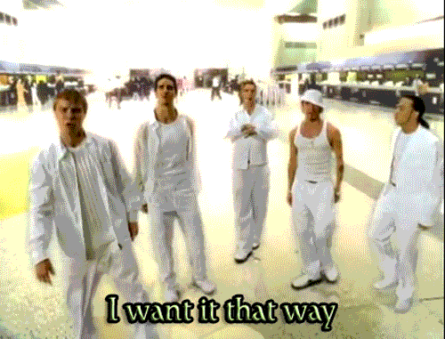 Animated GIF of The Backstreet Boys circa the 1990s. They are dressed in all white and singing, "I want it that way."
