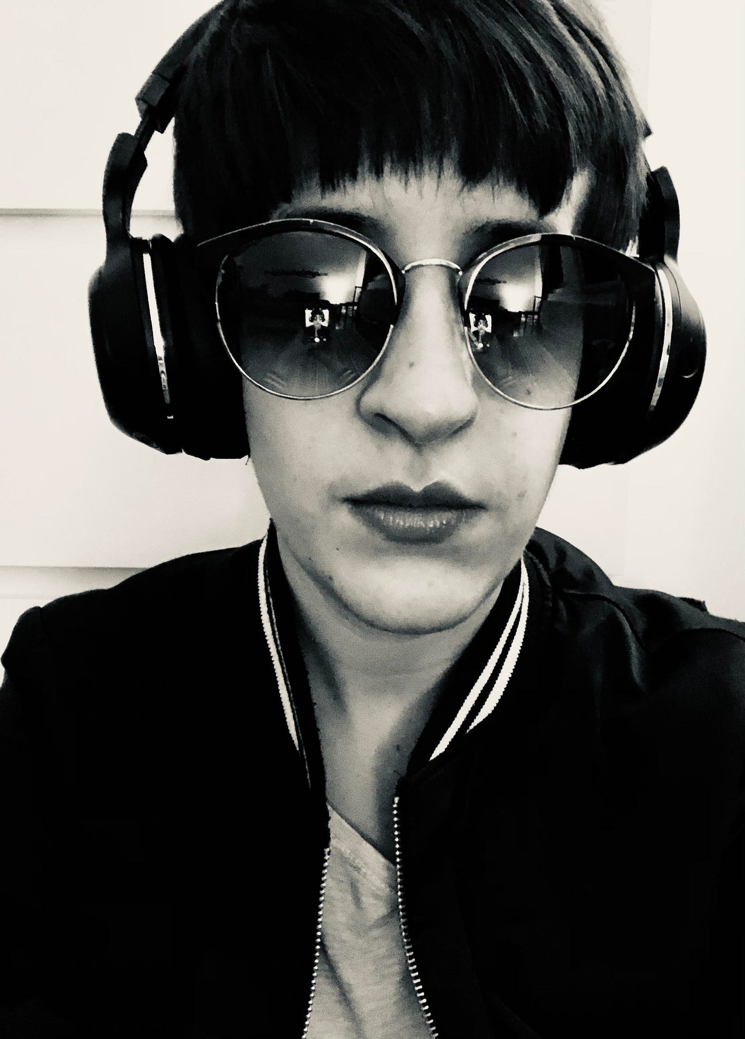 The author, wearing similar headphones, sunglasses, and jacket.