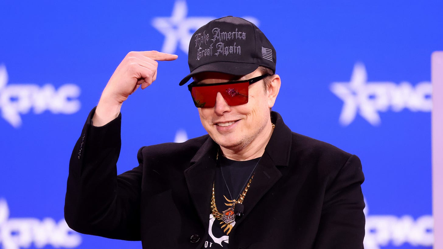 Elon Musk wearing sunglasses and pointing to a black Make America Great Again hat on his head Elon Musk wearing sunglasses and pointing to a black Make America Great Again hat on his head