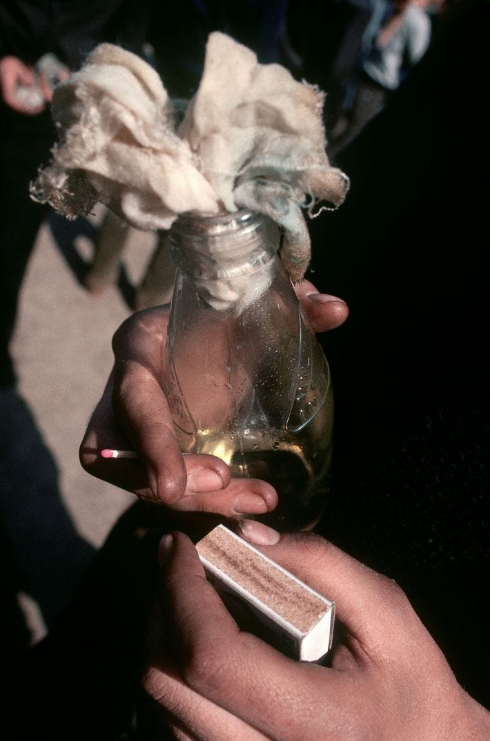 A rioter in Belfast prepares a Molotov cocktail during a 1981 march in support of Bobby ...