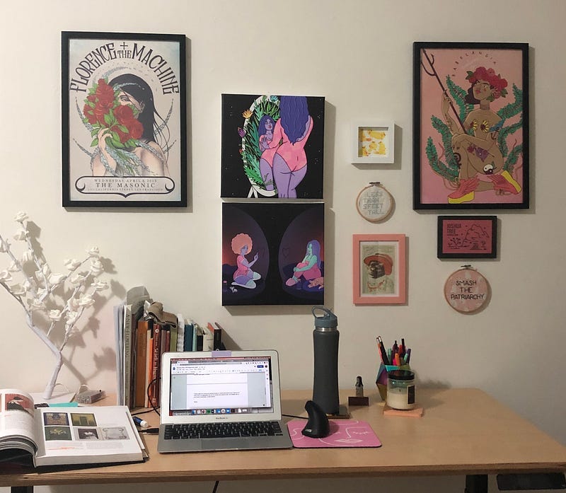 view of desk area with framed artwork on the wall