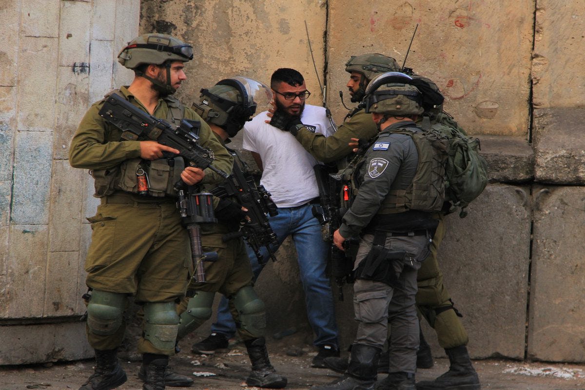 Israeli forces arrest a Palestinian man after the identity questioning in Hebron, West Bank on October 13, 2022 [Amer Shallodi/Anadolu Agency]