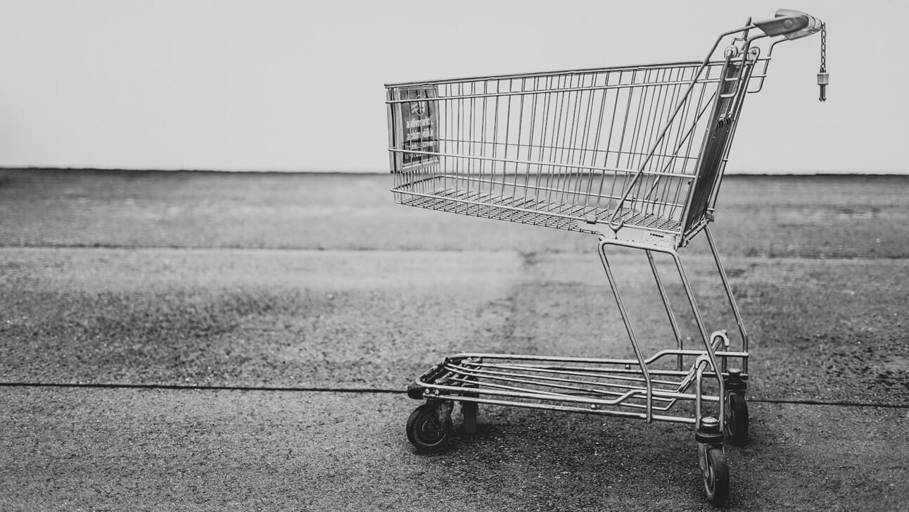 a black and white picture of a single shopping cart a black and white picture of a single shopping cart