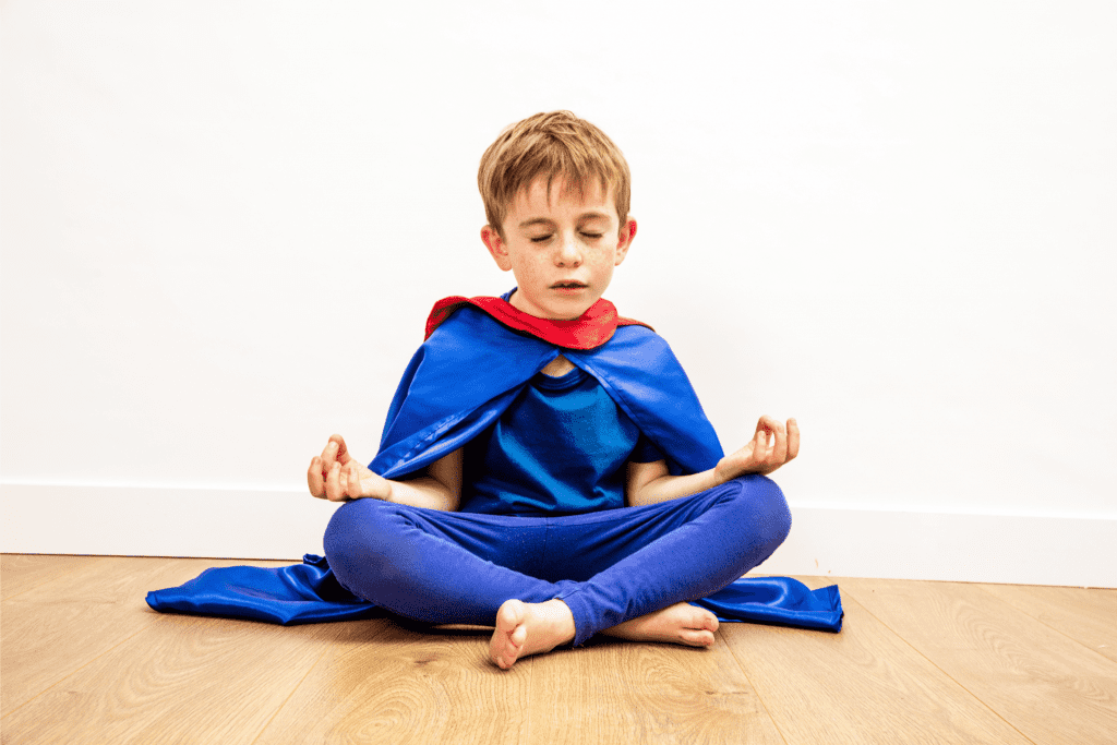 quiet superhero child breathing with zen yoga mindfulness for strength