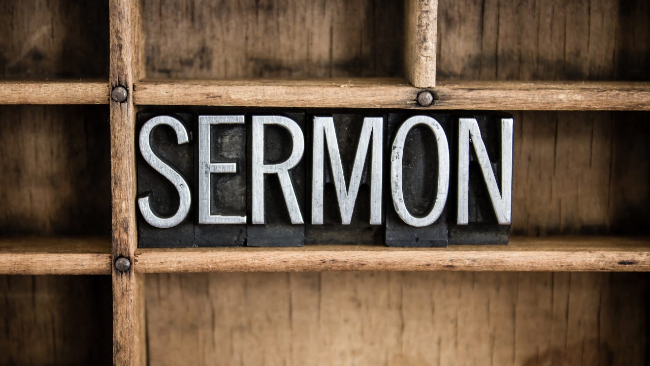 The word "Sermon" in black block letters on a wooden shelf.