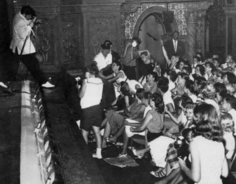 Elvis Presley performing at the Olympia Theater on August 3, 1956.