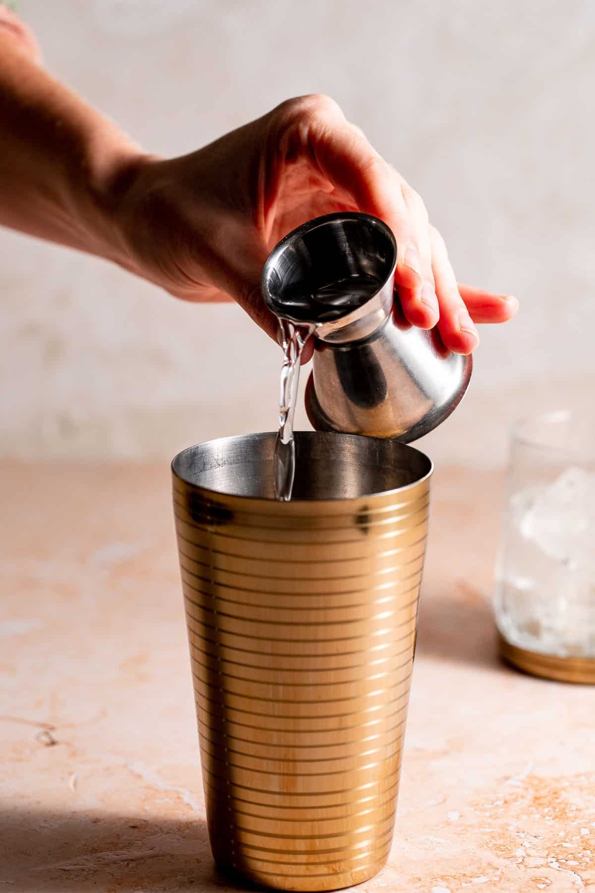 creme de menthe pouring into a drinks shaker