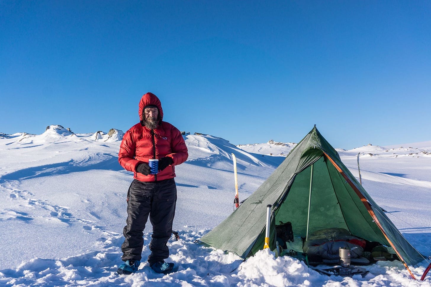 Townsend stands next to tent in snow