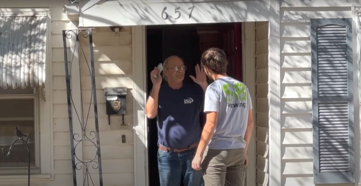 Spencer B. speaks to U.S. veteran who holds a handful of cash at his front door.