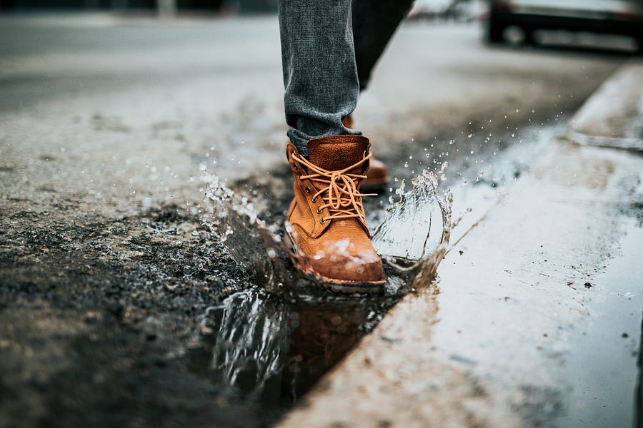 shoe stepping into water.