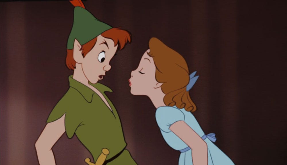 Peter Pan pulls back nervously while Wendy approaches for a kiss in 1953 Disney animation Peter Pan