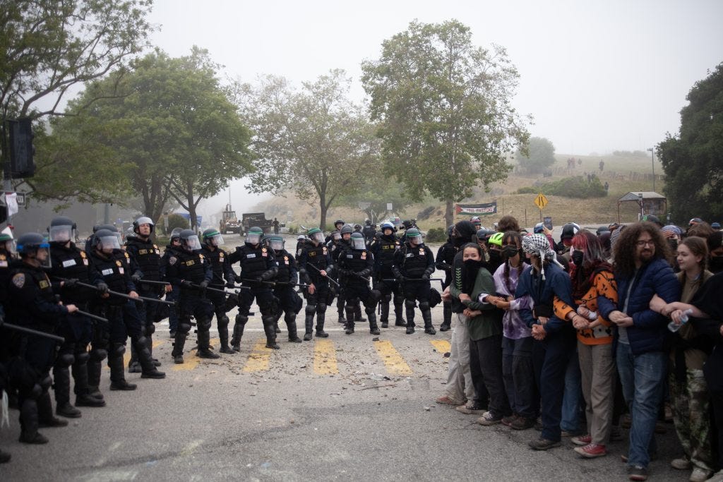 In the early morning of May 31, heavily armed police in riot gear surrounded student protesters. (Photo: Kyle Allemand)