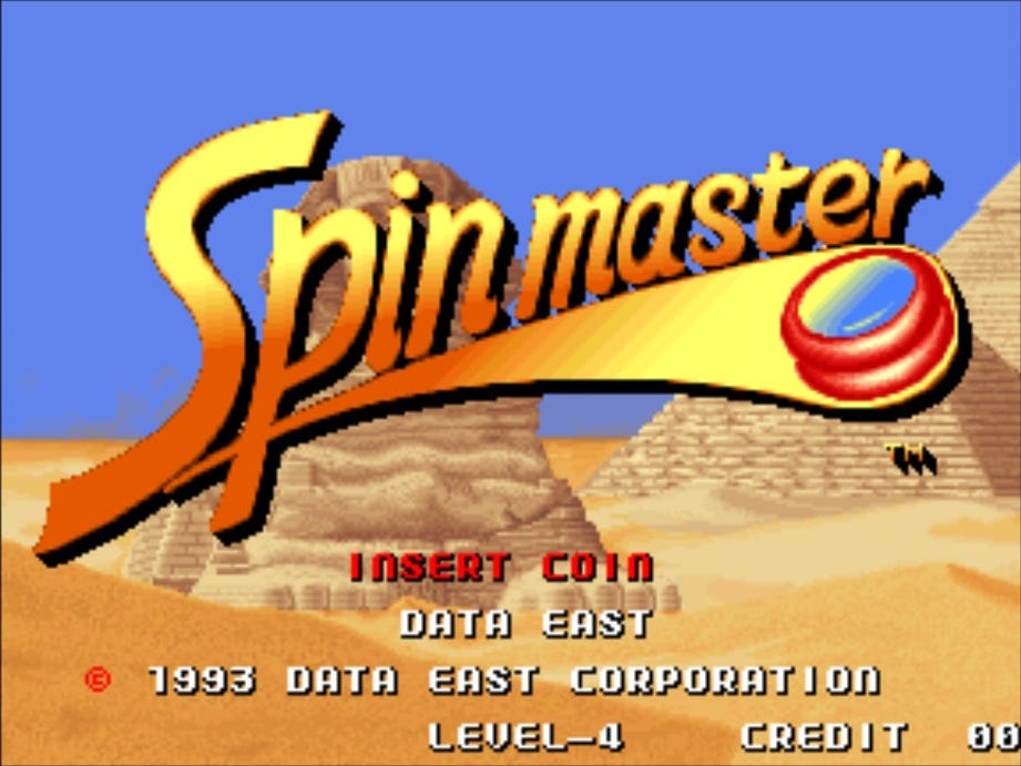 A screenshot of Spinmaster's title screen, featuring the Sphinx and a pyramid behind it, in the Egyptian desert. The game's logo cuts left to right across the screen, a la Indiana Jones, only one word.