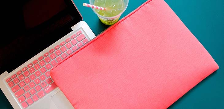 Photo of a laptop with pink keys.