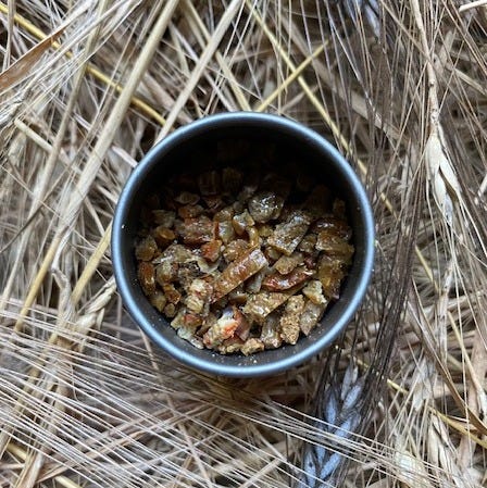 small tin of propolis on wheat