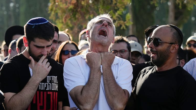 Yigal Sarusi, center, mourns during the funeral of his son, slain hostage Almog Sarusi, who was killed in Hamas captivity in the Gaza Strip, at a cemetery in Ra'anana, Israel