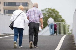 An elderly couple walking together
