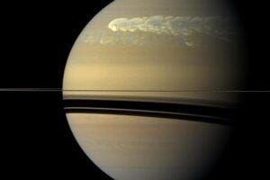 A huge storm dominates the rather featureless surface of Saturn in an image taken by the Cassini spacecraft on Feb. 25, 2011, about 12 weeks after the powerful storm was first detected in the planet's northern hemisphere. The megastorm is seen overtaking itself as it encircles the entire planet. Astronomers have found deep in the atmosphere the aftereffects of megastorms that occurred hundreds of years ago. The dark stripes are the shadows of Saturn's rings.