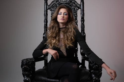 Free Woman in Black Clothes Posing on Throne Stock Photo