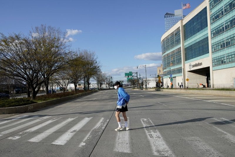 A man wears a protective face mask crossing a quiet West Side Highway in Manhattan during rush hour amid the onset of the coronavirus pandemic in April 2020. File Photo by John Angelillo/UPI