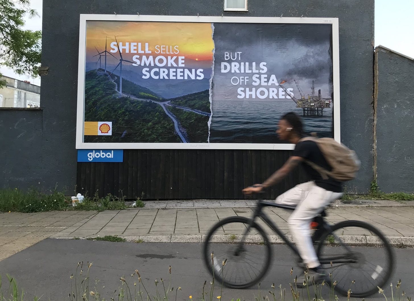 A billboard that has been “subvertised” by activists in Bristol (UK) to say "Shell sells smoke screens but drills off sea shores"