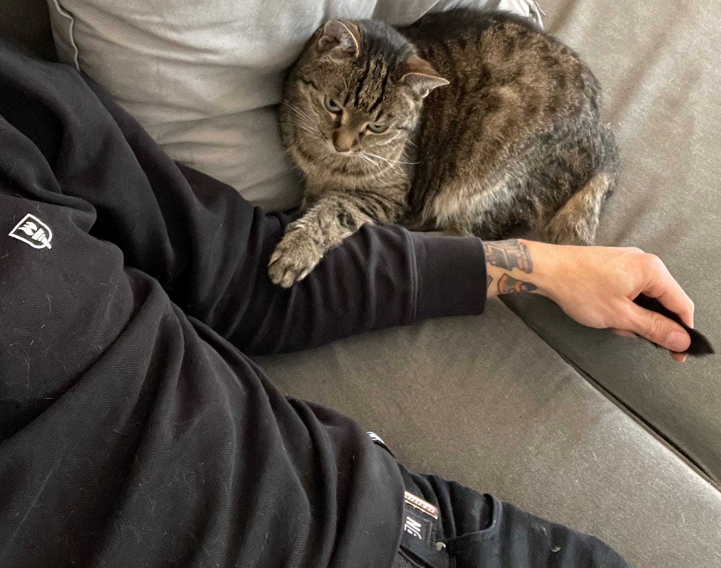 Chris kuddling with his cat Harry