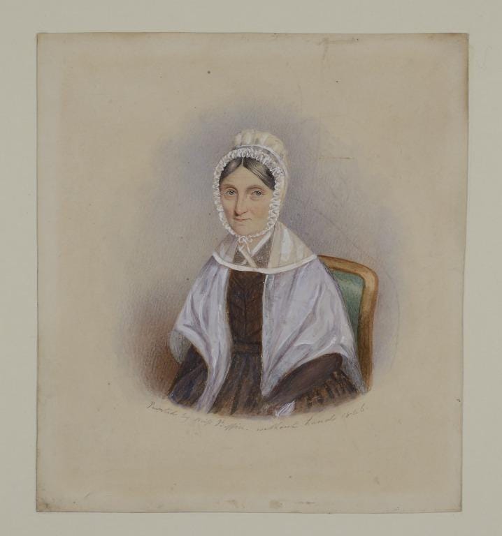 A portrait of a mature woman in a lace cap done up under her chin, and a white shawl over a dark-coloured dress of an 1840s style. She has neat straight grey hair tucked under her cap. She is very faintly smiling and looks like a kind person.