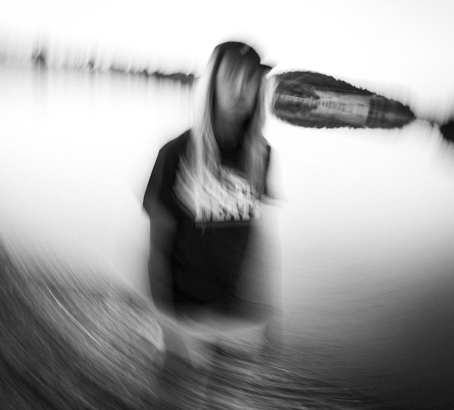 Blurry image of a female runner standing in front of a lake