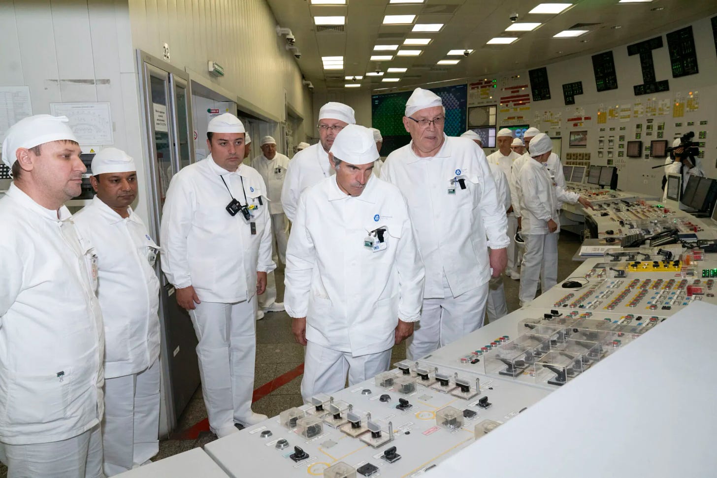 Officials in cleanroom suits tour Kursk nuclear plant