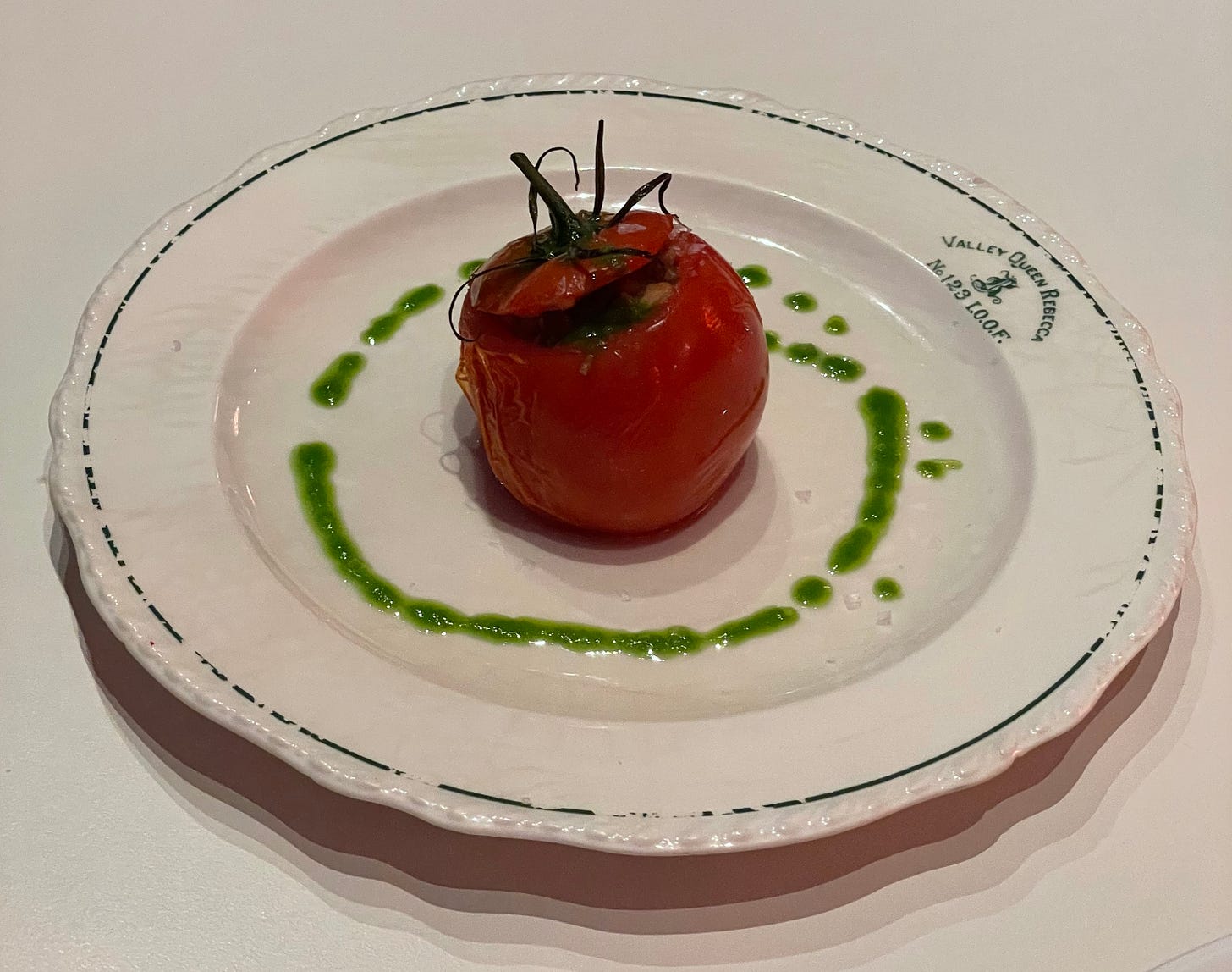stuffed tomato with oil on a plate