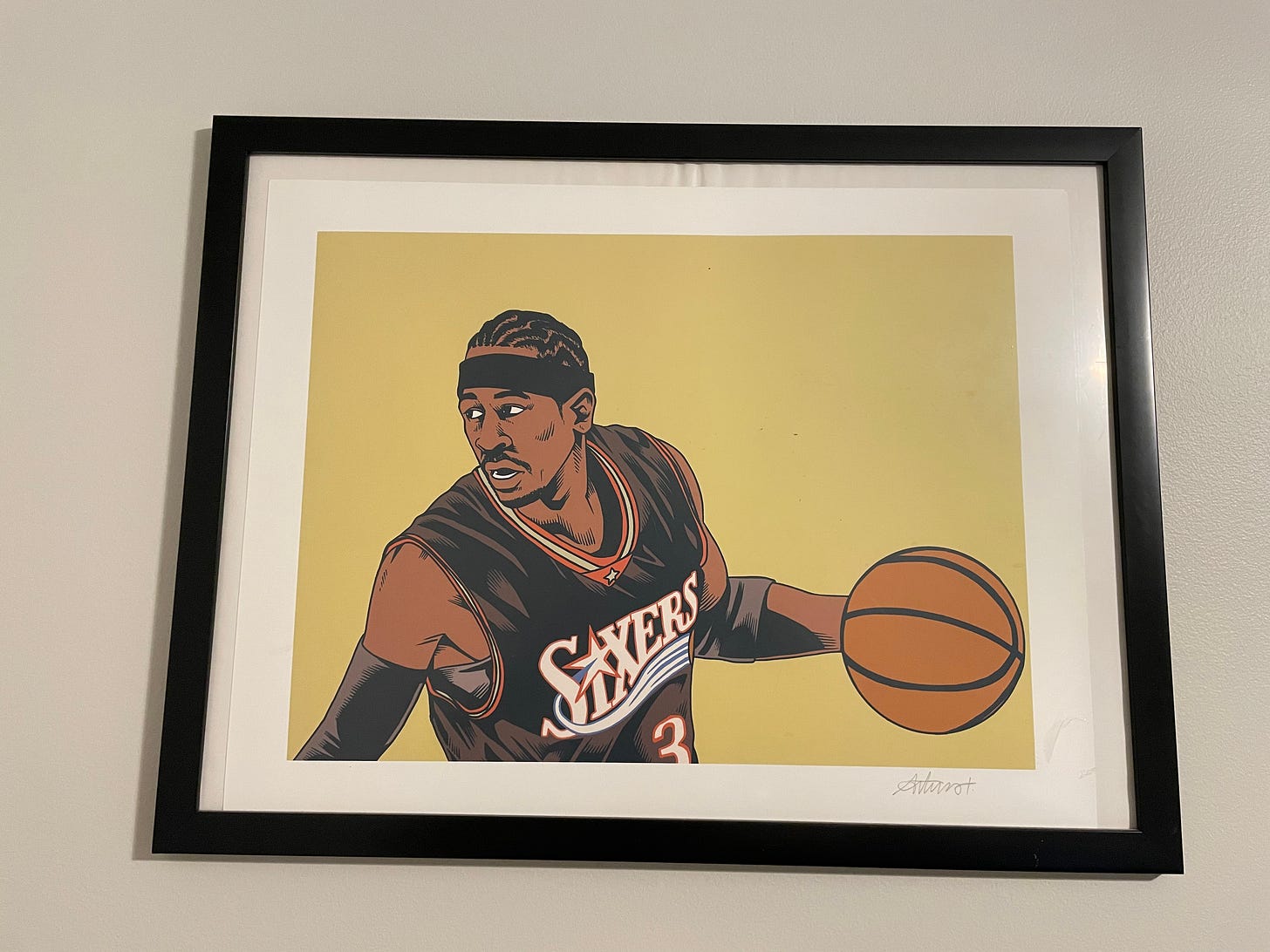 a print of a drawing of Allen Iverson wearing a black 76ers jersey looking over his shoulder and driving left