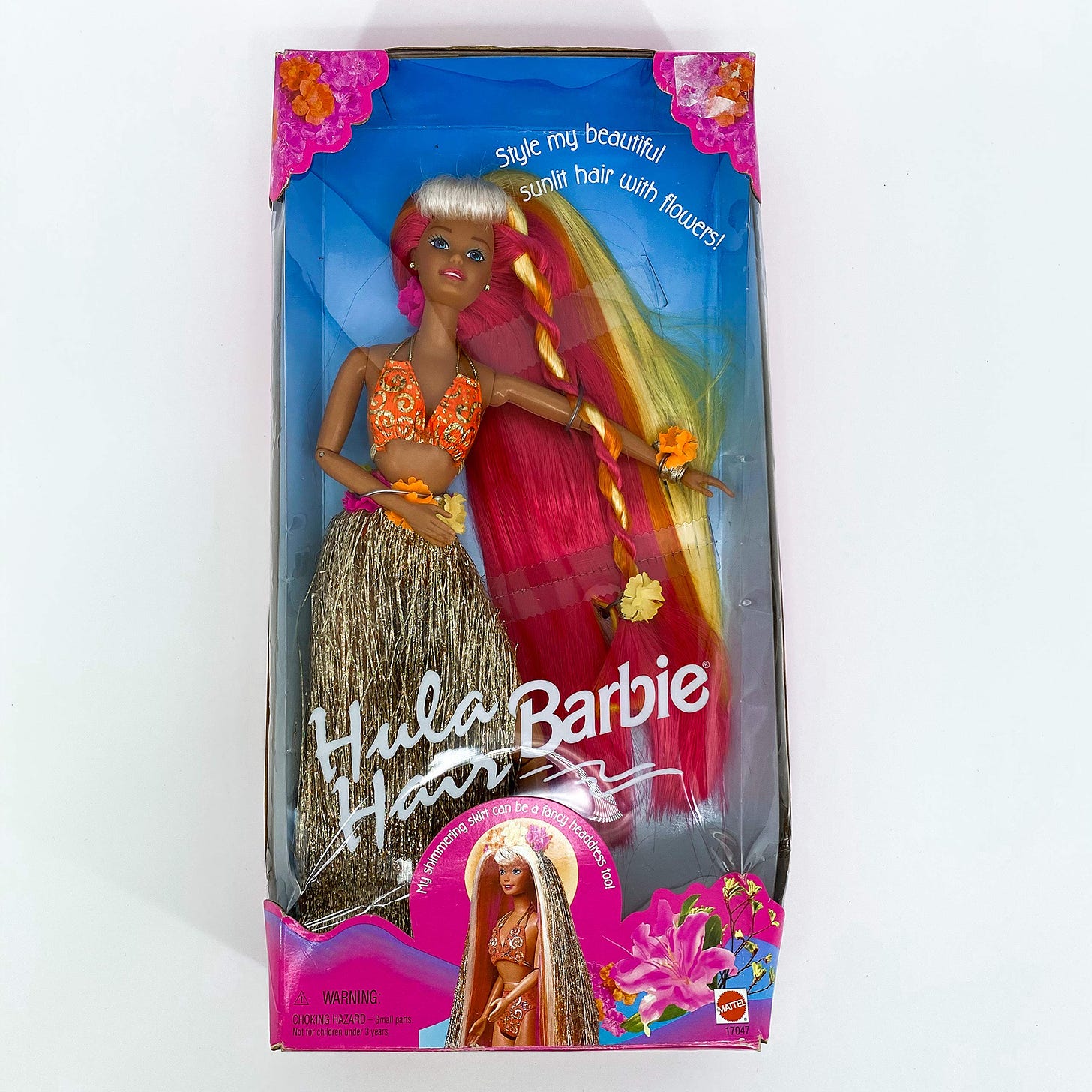 Hula Hair Barbie in her original box with sunset coloured hair, an orange bikini and a sparkly hula skirt
