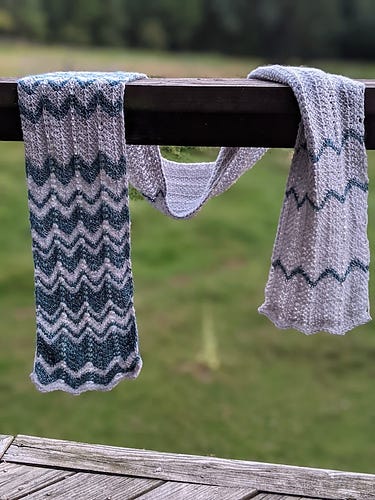 A blue and white scarf in a chevron pattern
