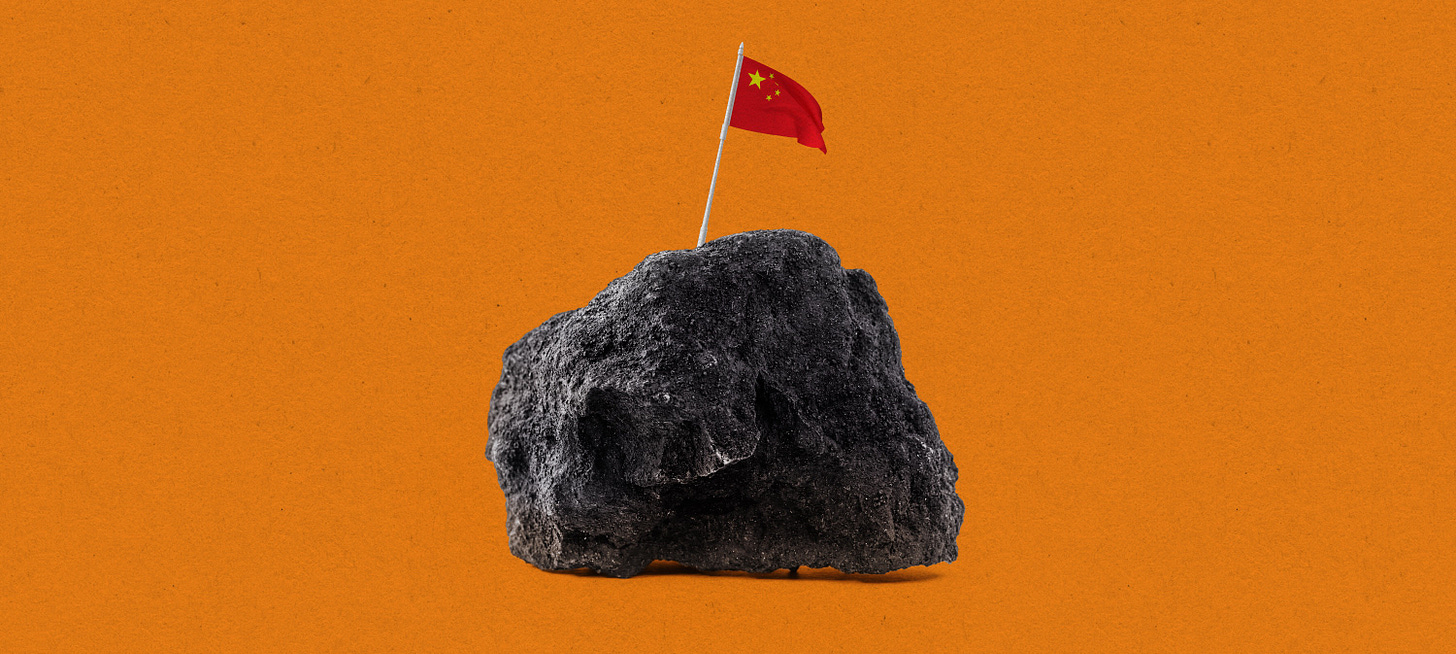 a tiny Chinese flag claiming a lump of graphite