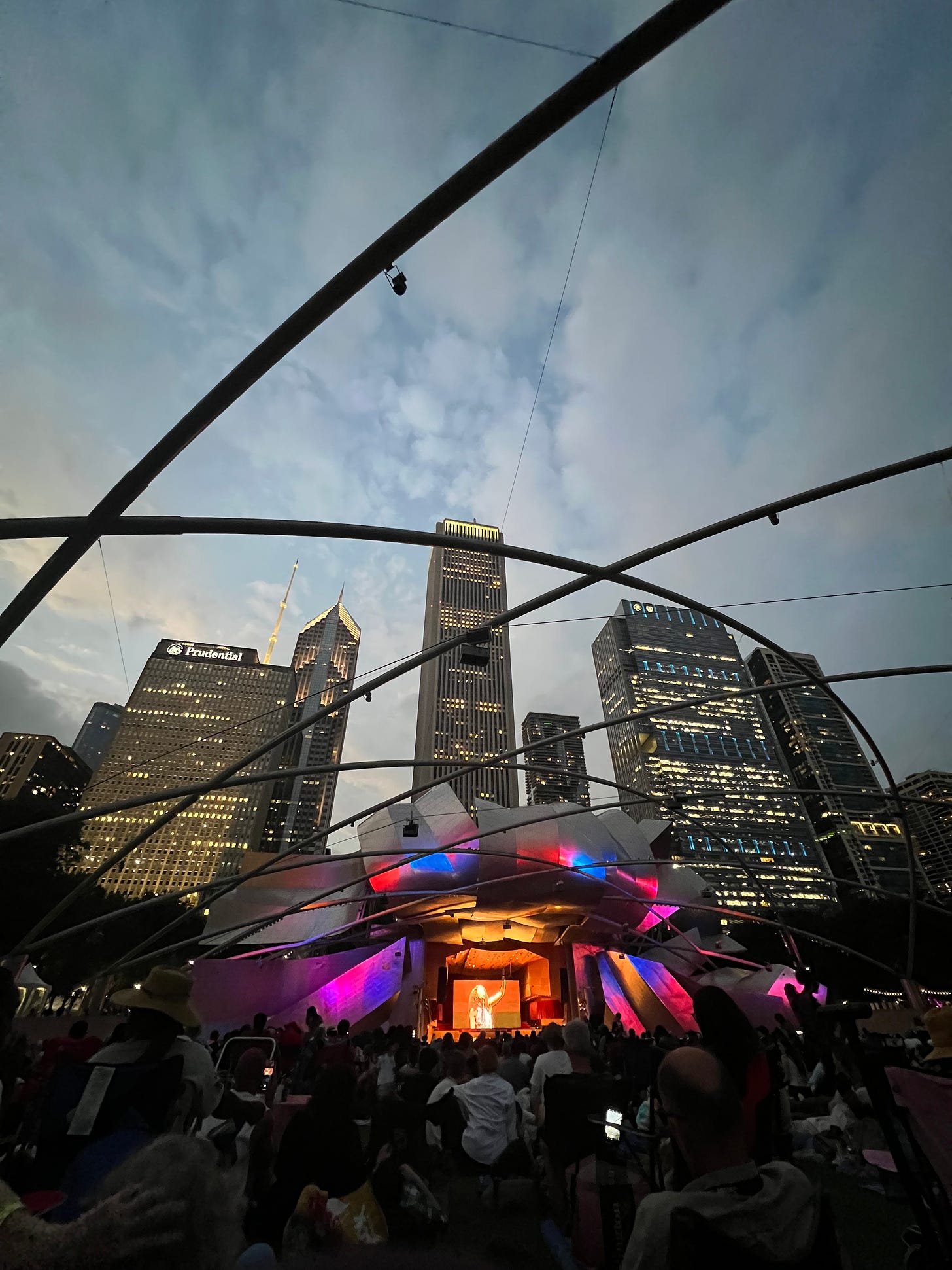 Jay Pritzker Pavilion in Millennium Park looking towards the stage and buildings behind it