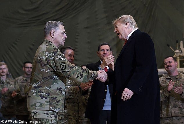 President Donald Trump shakes hands with Joint Chiefs Chairman General Mark Milley before addressing the troops at Bagram Air Field during a surprise Thanksgiving day visit, on November 28, 2019 in Afghanistan