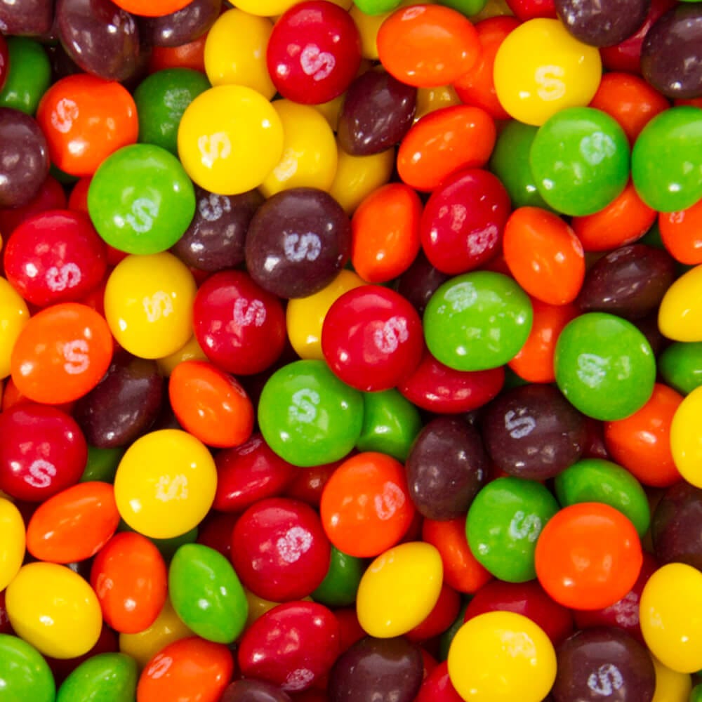 Skittles, in orange, red, green, yellow, and purple