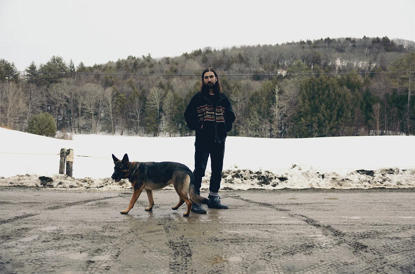 Noah Kahan pictured with his dog in the snow.