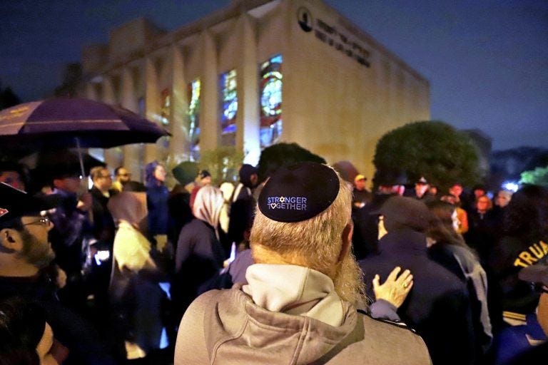 A group gathers outside the Tree of Life Synagogue for a vigil to honor the victims of the Saturday attack on synagogue in California Saturday April 27, 2019 in the Squirrel Hill neighborhood of Pittsburgh. It is six months to the day that a gunman shot and killed 11 people while they worshipped at the Tree of Life Synagogue on Oct. 27, 2018. (AP Photo/Gene J. Puskar)