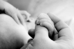 little-baby-hands-with-mom-and-dads-hands-3-1111673-m
