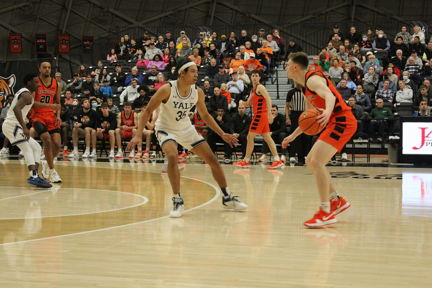 Isaiah Kelly of Yale (#35) guards Matt Allocco of Princeton during a game on Feb. 18, 2023. (Photo by Adam Zielonka)