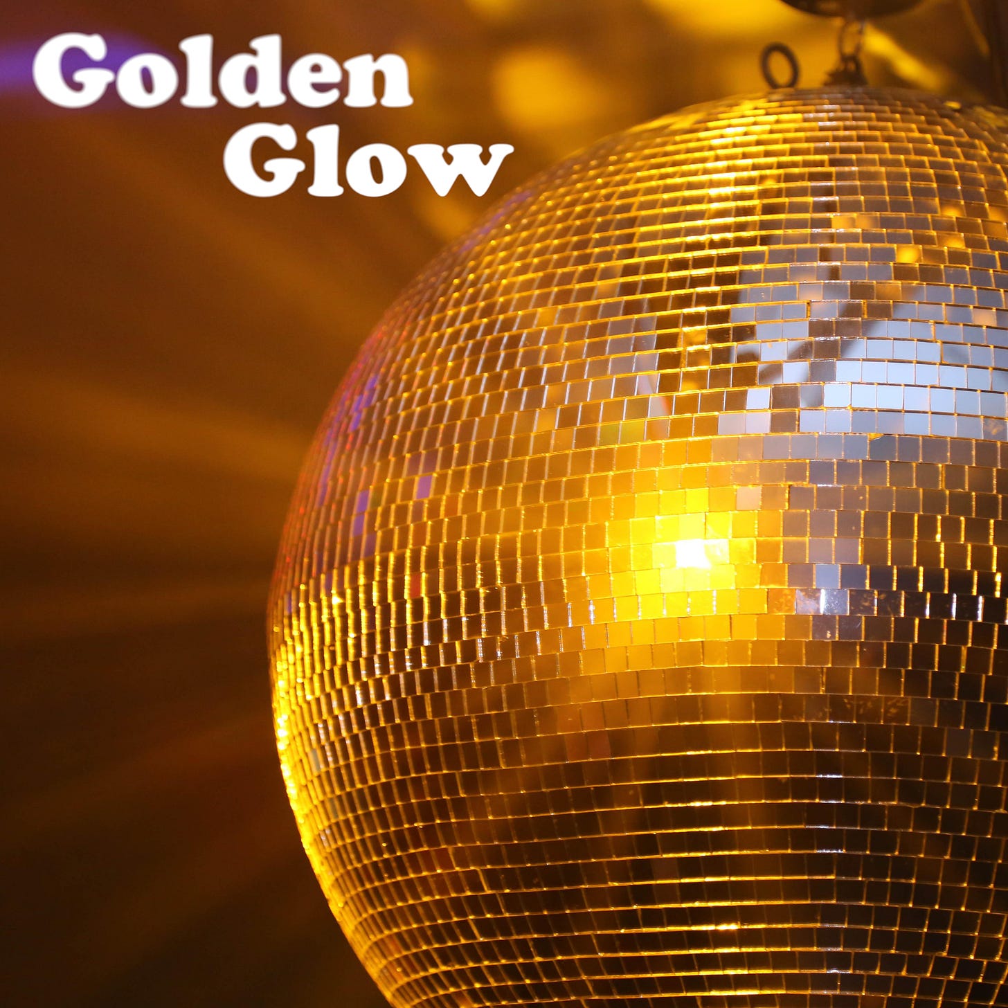 Golden disco ball with light reflecting. Text: Golden Glow