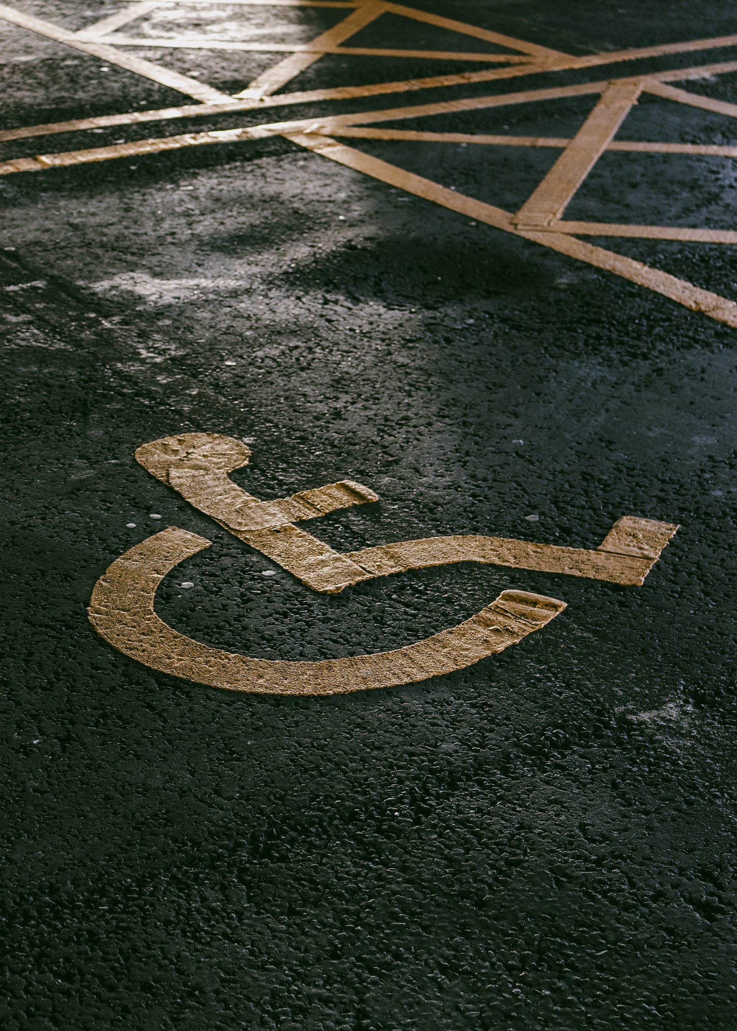 Wheelchair user symbol on a tarmac parking space