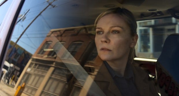 A shot of Kirsten Dunst through a car window in Civil War