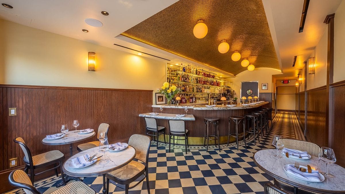 An interior with checkered floors and gold vaulted ceiling at Bar Sinizki.